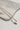 Image shows the Daphne Gold Heart Pearl Necklace against a marble background. Necklace has white pearl beads with small gold beads in between and a gold heart bead in center