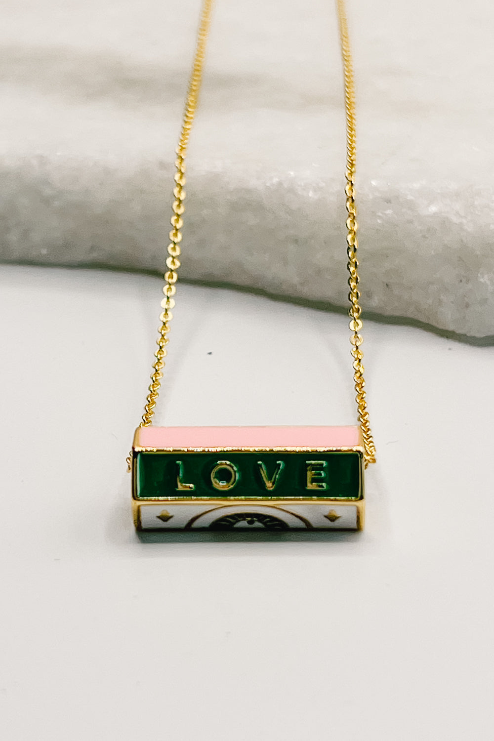 Photo shows a close-up of the LOVE necklace.