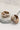 The photo shows an alternate view of the Meg earrings lying on a neutral background.