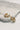 Close up of Juliette Gold and White Flower Hoops that are closed hoops. 