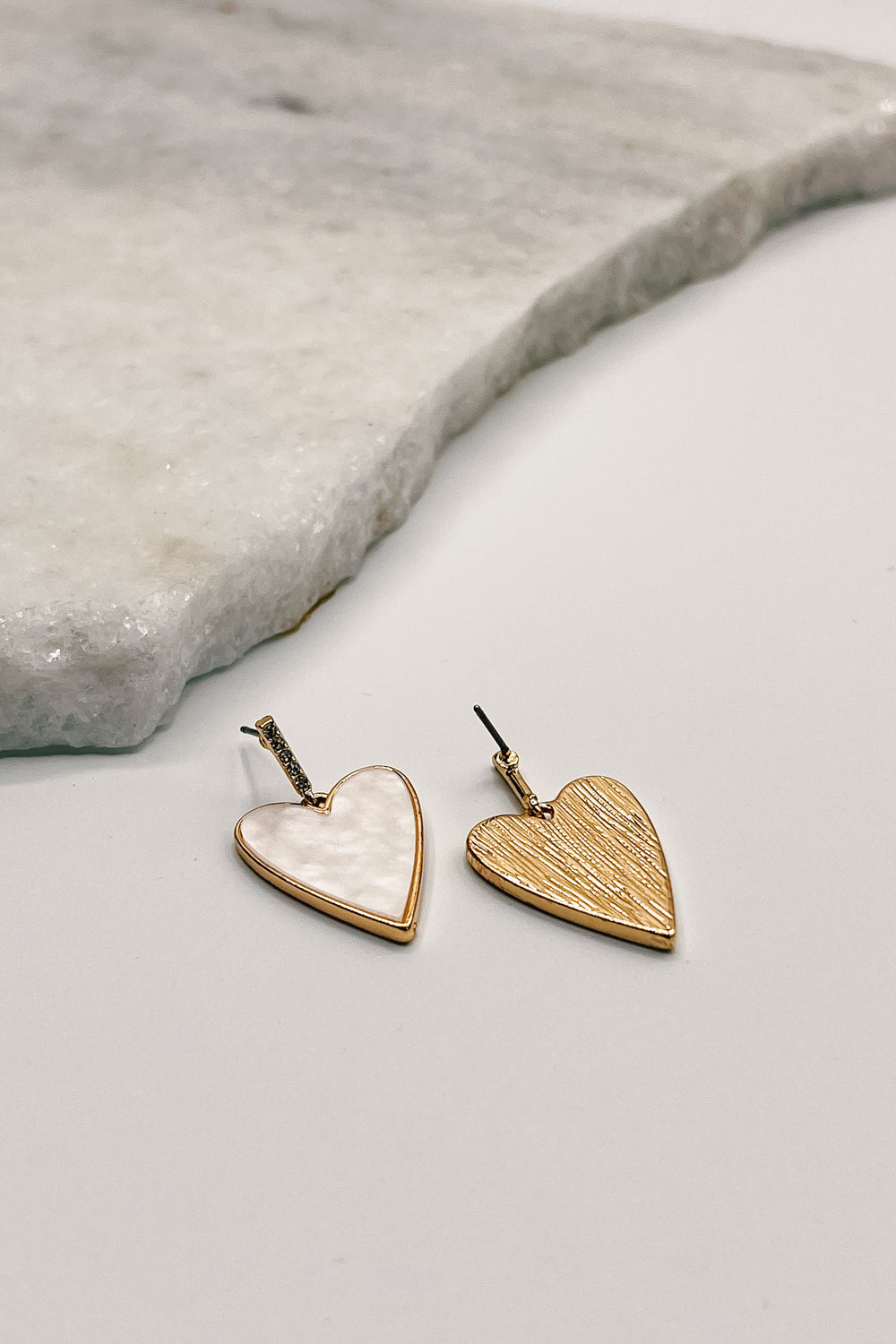 Close up of front and back of Emerson Gold and Cream Heart Earrings, gold shaped hearts filled with cream opal.