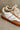 close up view of the Dixie Camel & White Lace Up Sneaker which features camel and white faux leather upper, round toe, brown rubber sole and lace up details