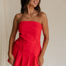 front view of female model wearing the Amaya Strapless Flare Mini Dress which features Lightweight Fabric, Side Zipper Closure, Belt Loops, Two Front Pockets, Strapless and Shorts Lining. the dress is available in red and navy blue