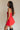 side view of female model wearing the Amaya Strapless Flare Mini Dress which features Lightweight Fabric, Side Zipper Closure, Belt Loops, Two Front Pockets, Strapless and Shorts Lining. the dress is available in red and navy blue