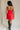 full body back view of female model wearing the Amaya Strapless Flare Mini Dress which features Lightweight Fabric, Side Zipper Closure, Belt Loops, Two Front Pockets, Strapless and Shorts Lining. the dress is available in red and navy blue