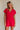 front view of female model wearing the Margot Tie Waist Short Sleeve Romper which features Elastic Waistband with Ties, Lightweight Fabric, V Neckline, Short Sleeves and Side Pockets. the romper is available in red and blue.