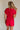 back view of female model wearing the Margot Tie Waist Short Sleeve Romper which features Elastic Waistband with Ties, Lightweight Fabric, V Neckline, Short Sleeves and Side Pockets. the romper is available in red and blue.