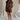 full body view of female model wearing the Thea Brown Ribbed Shorts which features Brown Ribbed Fabric, Two Side Pockets, Elastic Waistband with Drawstring Tie and Gold Hardware Details
