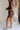 side view of female model wearing the Thea Brown Ribbed Shorts which features Brown Ribbed Fabric, Two Side Pockets, Elastic Waistband with Drawstring Tie and Gold Hardware Details