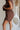 side view of female model wearing the Thea Brown Ribbed Shorts which features Brown Ribbed Fabric, Two Side Pockets, Elastic Waistband with Drawstring Tie and Gold Hardware Details