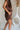 side view of female model wearing the Thea Brown Ribbed Shorts which features Brown Ribbed Fabric, Two Side Pockets, Elastic Waistband with Drawstring Tie and Gold Hardware Details