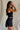 side view of female model wearing the Esme Black Sleeveless Tank which features Black Lightweight Fabric, Cropped Waist, Built In Bra, Square Neckline and Sleeveless