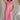 Front view of female model wearing the Lumi Coral Short Sleeve Maxi Dress that has light coral fabric, short sleeves, and side pockets.