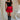 Full body front view of female model wearing the Nina Bow Detail Mini Skirt in Red that has red fabric, black bows in the middle, and an elastic waist. Worn with black top and black boots.