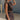 Side view of model wearing Tatum Mini Skirt in espresso. This is a mini skirt with a drawstring waistband, bubble hem, and mini length.