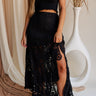 Close up of model wearing Lana Black Crochet Skirt. This is a black crochet midi skirt with slit detail.