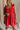 Close up of model wearing Gabby Red Romper. This is a washed red romper with fray details.