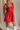 Close up of model wearing Gabby Red Romper. This is a washed red romper with fray details.