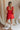 Back view of model wearing Gabby Red Romper. This is a washed red romper with fray details.