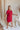 Side view of model wearing Hailey Crimson Red Mini Dress. This is a washed crimson red dress with fray hem, collared neckline, short sleeves.