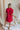 Back view of model wearing Hailey Crimson Red Mini Dress. This is a washed crimson red dress with fray hem, collared neckline, short sleeves.