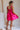 Back view of model wearing Carly Hot Pink Mini Dress. This is a hot pink mini dress, corset looking top and sleeveless.