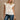 Colette Cream Peplum Flare Sleeveless Top- close up top view