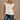 Colette Cream Peplum Flare Sleeveless Top- close up top view