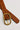 Image shows the Marcy Brown Embroidered Belt against a white background. Belt has brown faux leather with brown embroidery and a gold oval buckle.