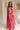 Full body view of female model wearing the Luna Orange & Fuchsia Floral Maxi Dress which features Fuchsia, Red Orange and Linen Floral Print, Linen Lining, Strapless, Back Tie Detail and Maxi Length