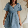 front view of female model wearing the Charlie Light Denim V-Wire Mini Dress which features Denim Wash Fabric, Mini Length, Square Neckline with V Wire, Smocked Back and Short Puff Sleeves