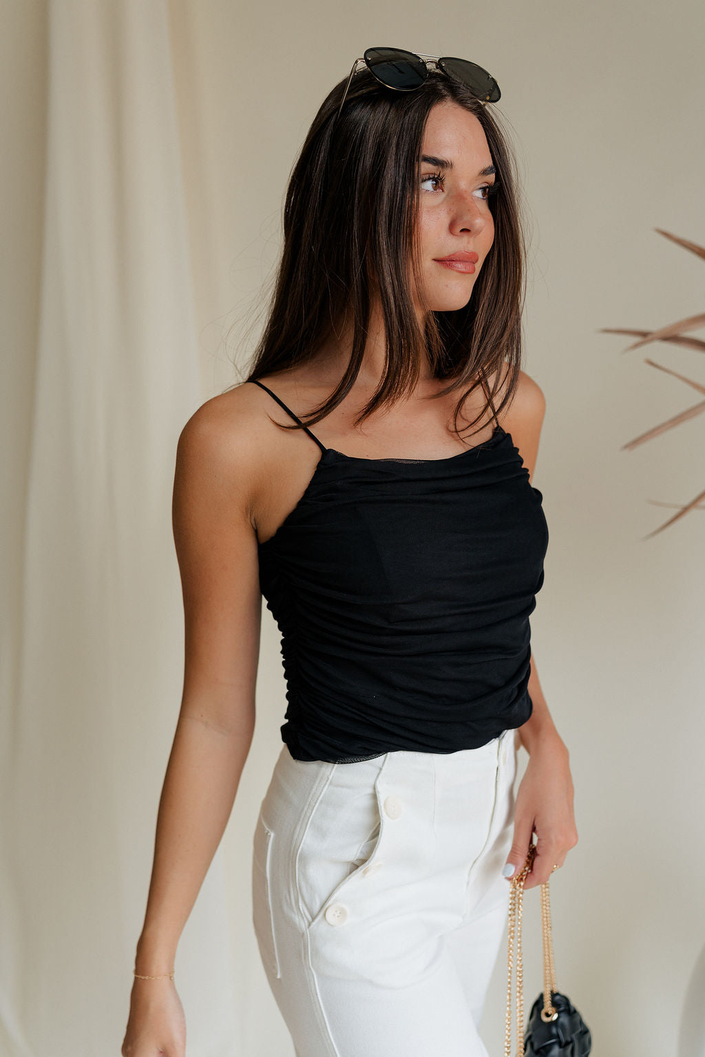 side view of female model wearing the Evie Black Ruched Tank which features Black Mesh Fabric, Black Lining, Ruched Details, Square Neckline and Adjustable Straps