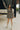 Full body view of model wearing the Nevaeh Black Pattern Mini Dress. This is a black mini dress with geometric pattern, squared neckline, long sleeves. 