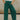 Close up view of model wearing the Emerson Pants in green. These are comfy pants with a ruched waistband, cargo pant look, comes in either black or green.