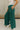 Close up view of model wearing the Emerson Pants in green. These are comfy pants with a ruched waistband, cargo pant look, comes in either black or green.