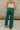 Close up back view of model wearing the Emerson Pants in green. These are comfy pants with a ruched waistband, cargo pant look, comes in either black or green.