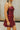 Side view of female model wearing the Anya Burgundy Faux-Leather Strapless Dress that has burgundy faux-leather fabric, a strapless neck, and mini-length hem.