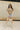 Full body view of model wearing the Millie Crochet Short Sleeve Sweater in khaki. This is a cropped sweater top, crochet, short sleeve, comes in either black, white, or khaki.