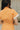 Close up view of model wearing the Tatum Orange and Cream Checkered Romper. This is an orange and cream checkered romper, with short sleeves, button up front, and a collared neckline.