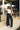 Full body view of model wearing the Emerson Pants in black. These are comfy pants with a ruched waistband, cargo pant look, comes in either black or green.