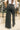 Close up back view of model wearing the Emerson Pants in black. These are comfy pants with a ruched waistband, cargo pant look, comes in either black or green.