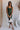 Model is pictured wearing the Nyla Olive Bodycon Midi Dress in a size small.