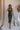 Model is pictured wearing the Nyla Olive Bodycon Midi Dress in a size small.