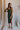 Model is pictured wearing the Nyla Olive Bodycon Midi Dress in a size small.