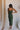 Model is pictured wearing the Nyla Olive Bodycon Midi Dress in a size small.