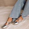 Side view of model's feet; model is wearing the Polly Silver Ballet Flats with jeans.