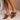 Side view of model's feet; model is wearing the Keira Mocha Bow Mule Heels.