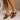 Side view of model's feet; model is wearing the Keira Mocha Bow Mule Heels.