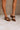 Front view of model's feet; model is wearing the Keira Mocha Bow Mule Heels.