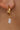 Aria Gold Rhinestone Dangle Huggie Earring- close up side view